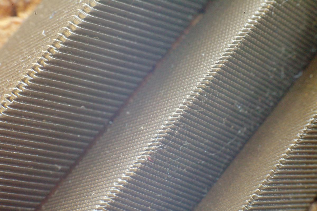 Closeup of two saw files and in the center a 3 square file