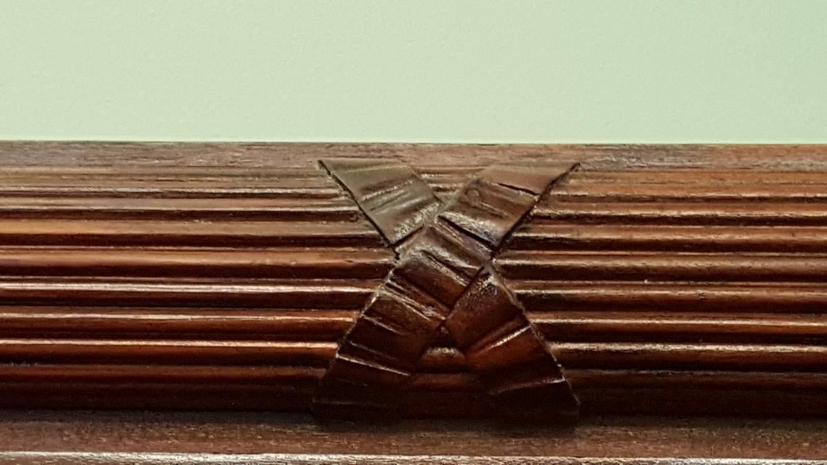 Wonderful carved insert placed in various intervals along the molding atop the wainscotting  around the room