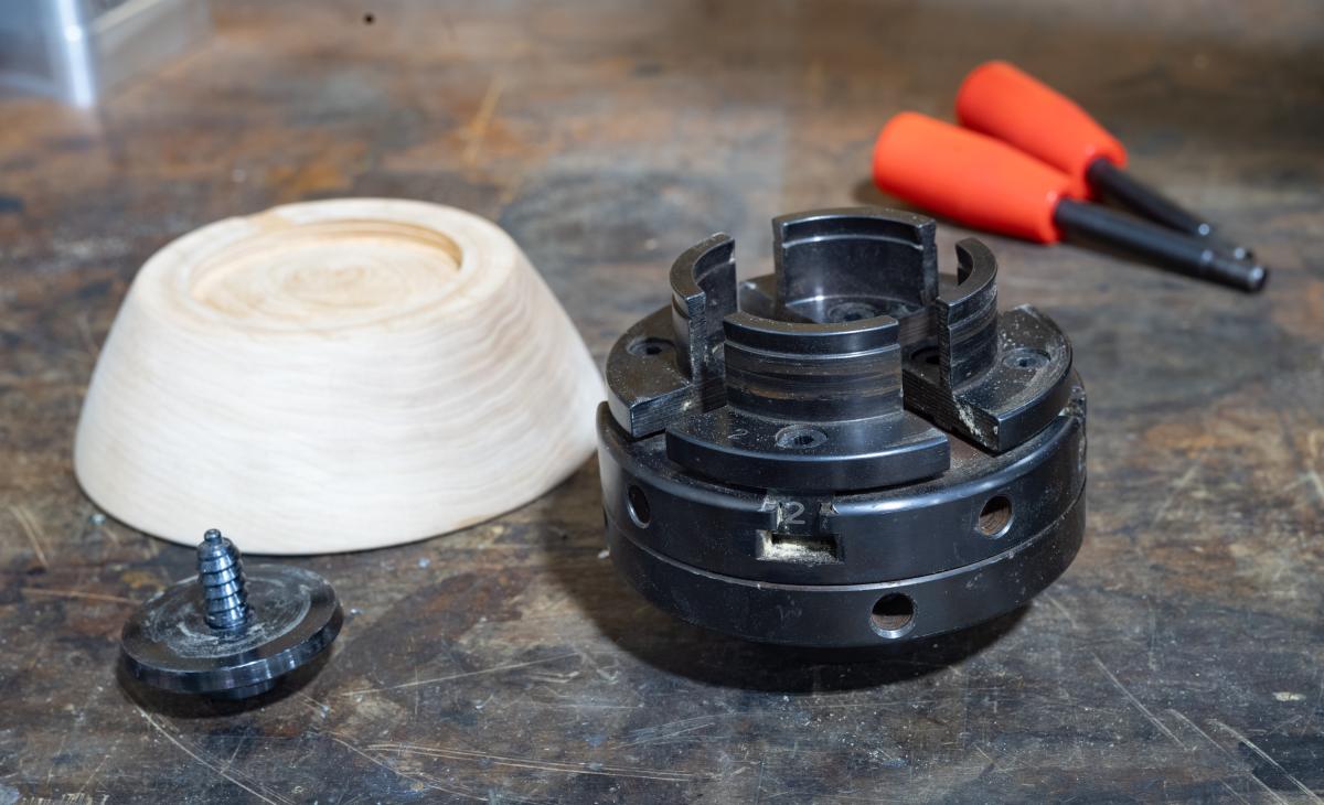  A screw chuck (left)  and a Four Jaw Universal Chuck