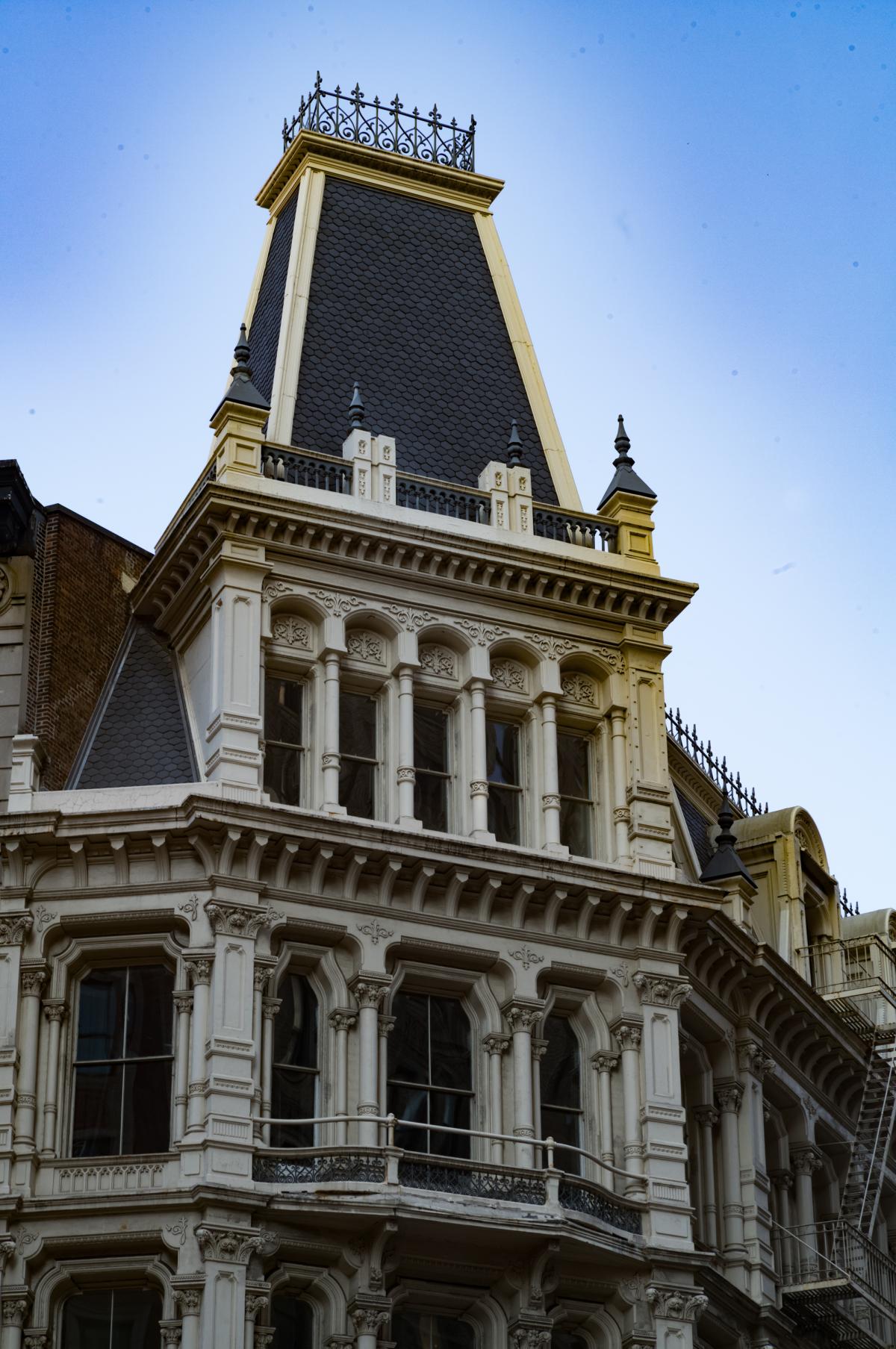 901 Broadway was built in 1870 as a home for Lord & Taylor. This remaining corner pavilion features a tall slate mansard roof in the the French Second Empire style.