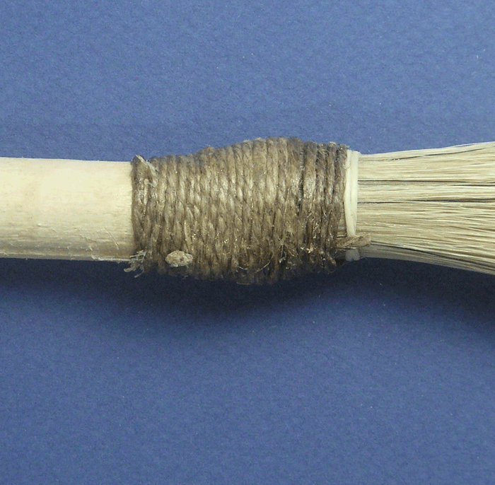 A finishing brush with the hair tied to the ferrule